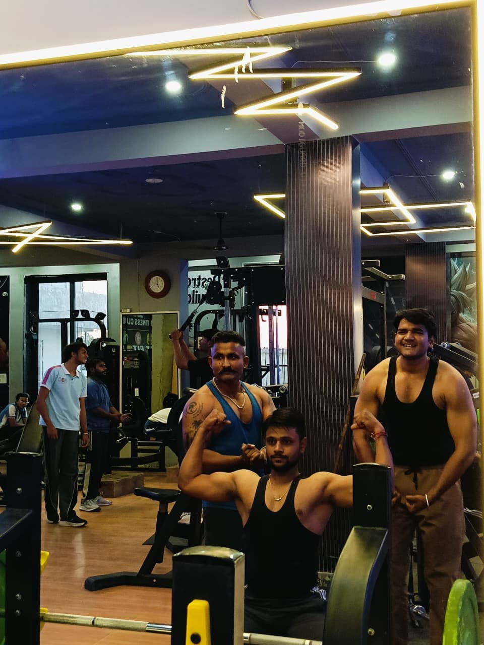 Members posing together in the mirror on G2 Fitness Club's training floor
